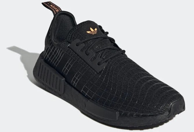 Side view of black adidas sneakers.